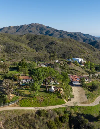 An aerial view of a home in the mountains.