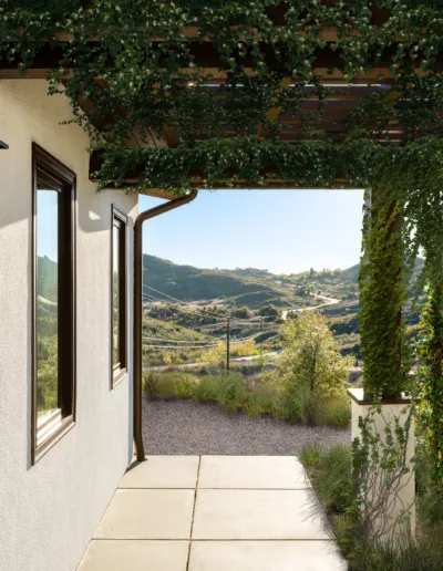 A house with a porch and a view of the mountains.